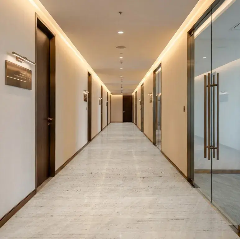 Office corridor with dark doors and glass partitions at 1970 Office Tower