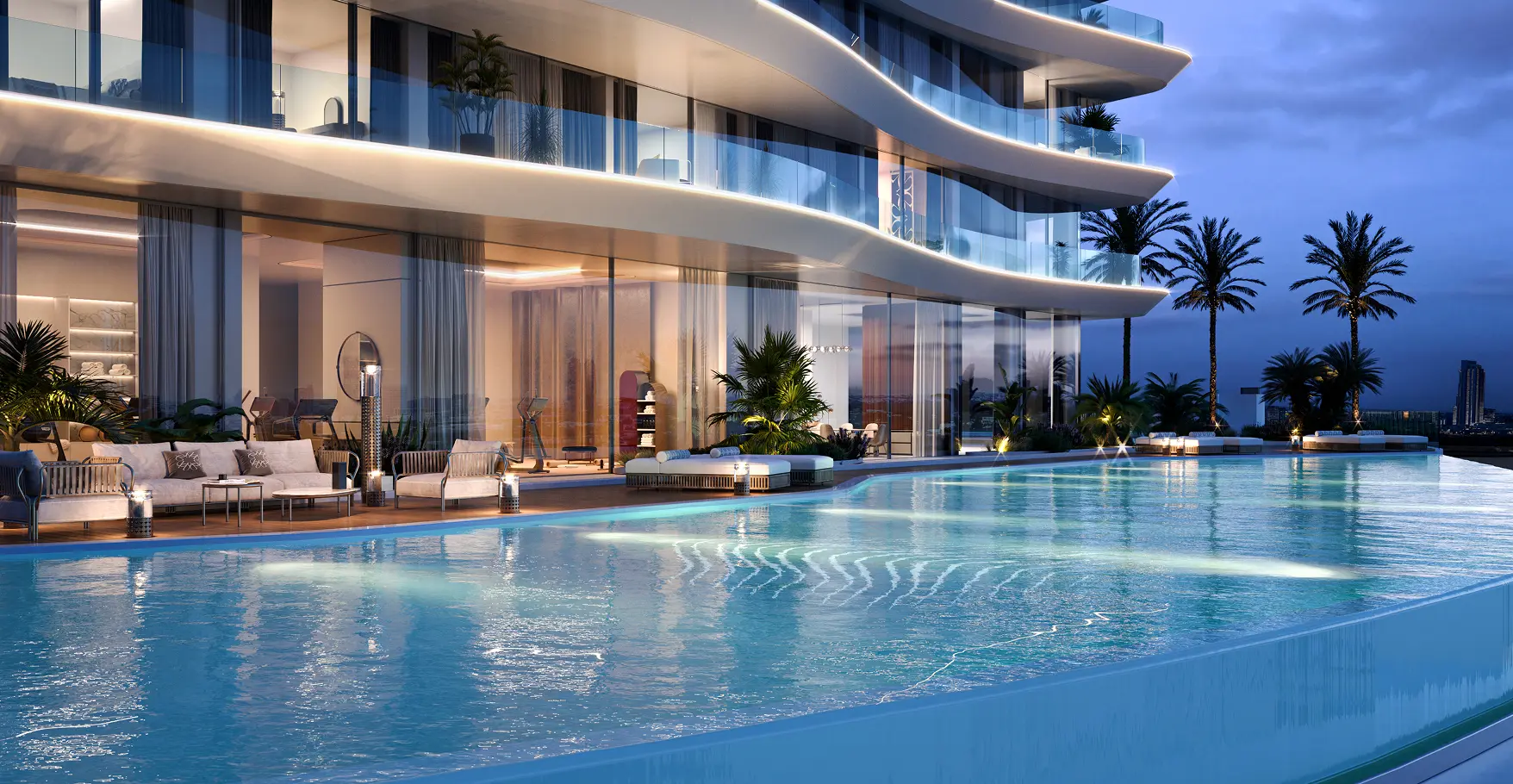 Azure outdoor pool at night at Elie Saab Waterfront by Ohana on Al Reem Island