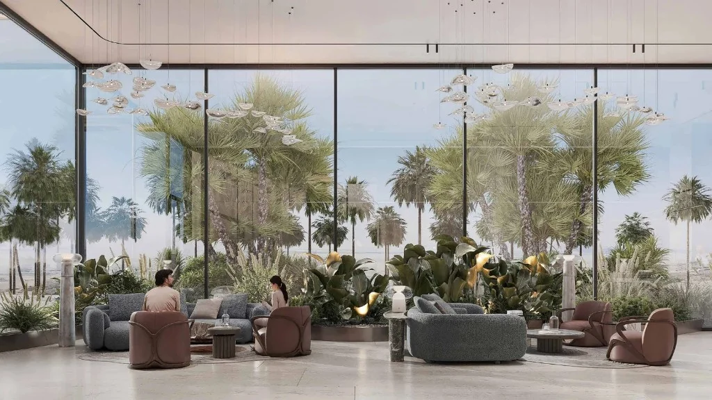 Lobby lounge with floor-to-ceiling windows and palm garden views at Manchester City Yas Residences by Ohana
