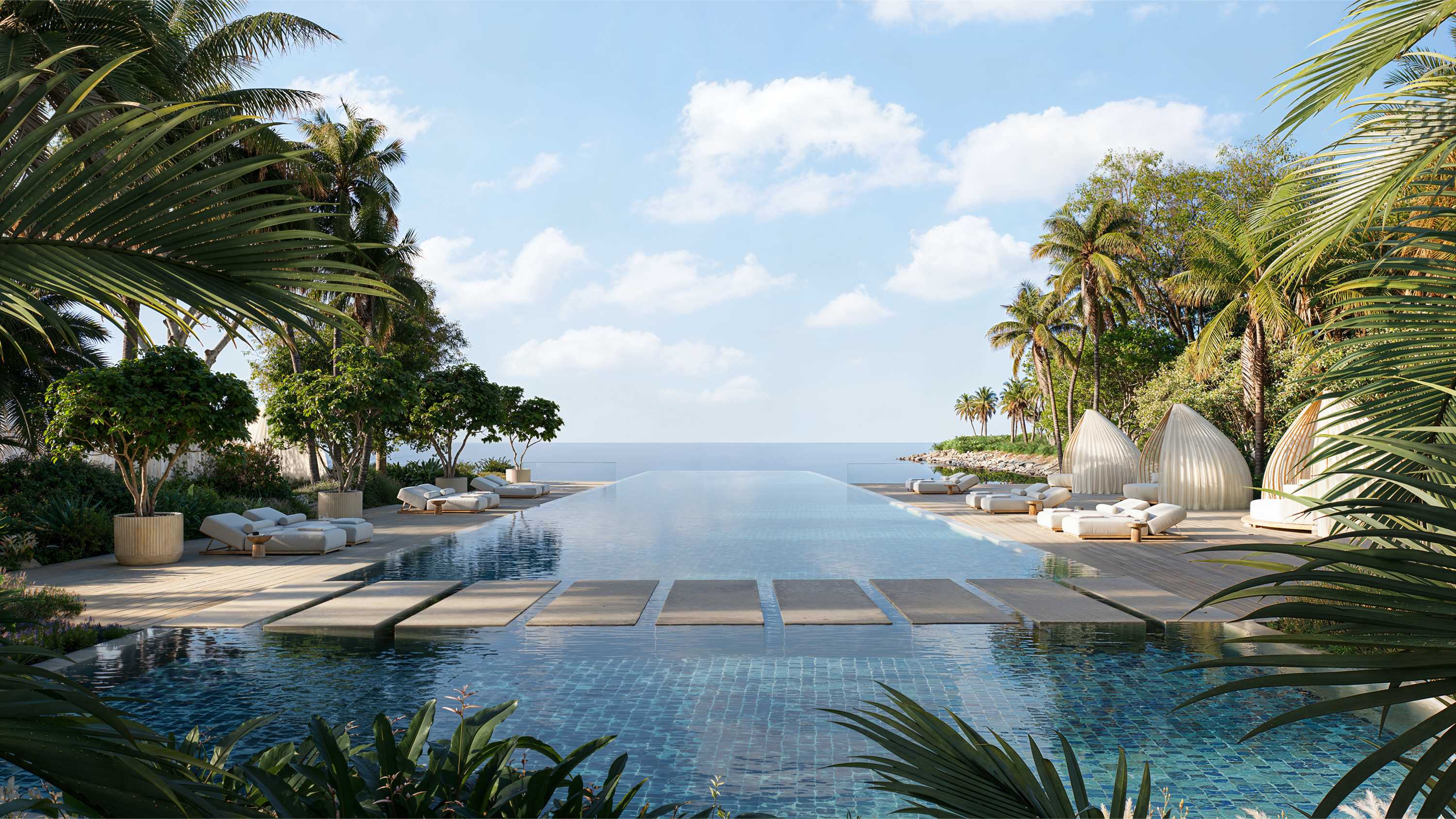 Infinity pools and beach lagoon cove at Jumeirah Asora Bay