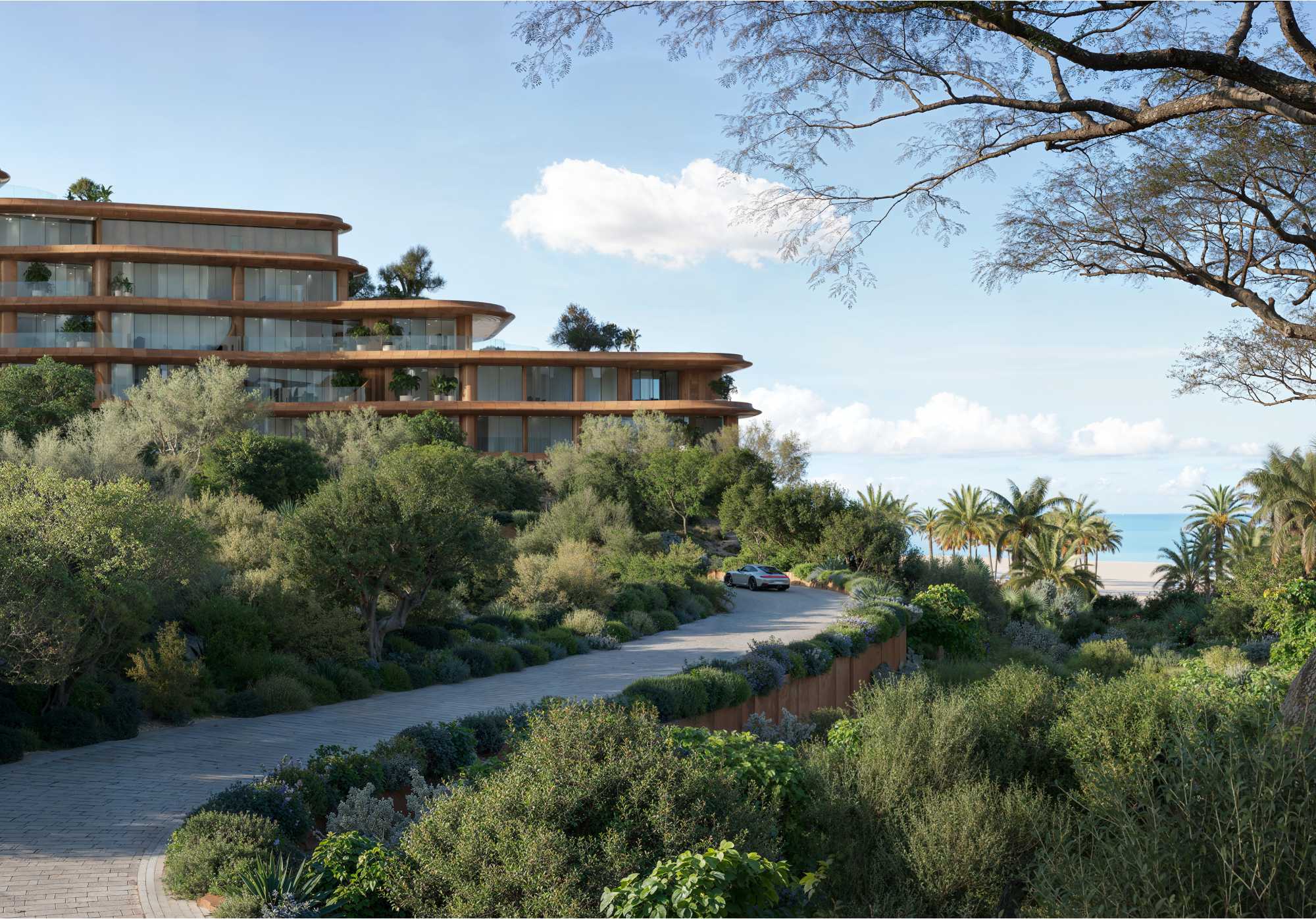Coastal gardens and hillside landscape at dusk at Jumeirah Asora Bay, La Mer