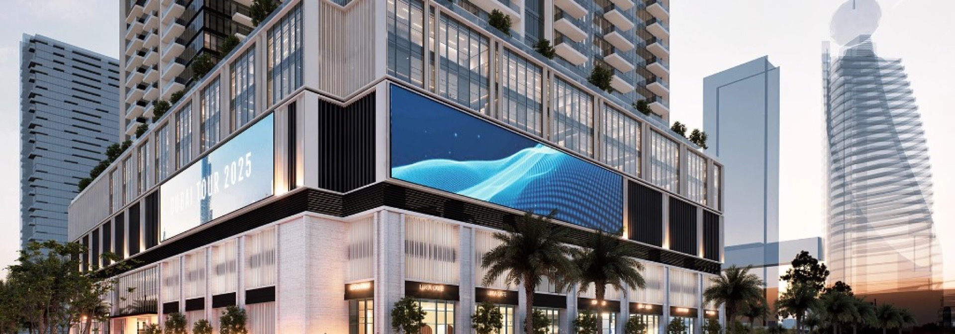 Avenue Park Towers II facade with ground-level retail and digital displays at dusk